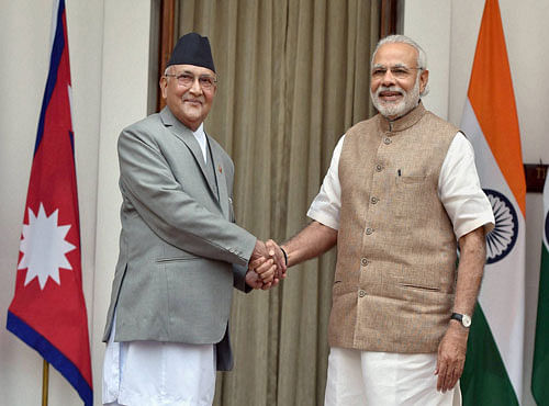 Prime Minister Narendra Modi and his Nepalese counterpart Khadga Prasad Sharma Oli shakes hands before a meeting at Hyderabad House in New Delhi on Saturday. PTI Photo
