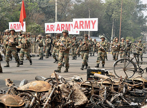 Army personnel conduct a flag march in Rohtak on Saturday. PTI