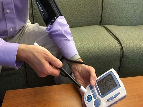 Dartmouth College Professor David Kotz demonstrates a commercial prototype of 'Wanda' imparting information such as the network name and password of a WiFi access point onto a blood pressure monitor. Credit: Dartmouth College