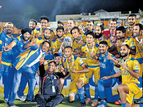 jubilant: Jaypee Punjab Warriors' side pose after winning their first-ever Hockey India League title on Sunday. PTI