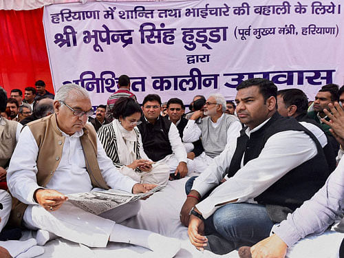 Former Haryana Chief Minister Bhupinder Singh Hooda with his supporters staging indefinite fast at Jantar Mantar until peace is restored in the Haryana, in New Delhi on Sunday. PTI Photo