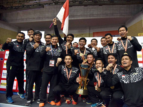 Indonesia team celebrates with Gold trophy after defeating Japan in final by 3-2, at the Badminton Asia Team Championships in Hyderabad on Sunday. PTI Photo
