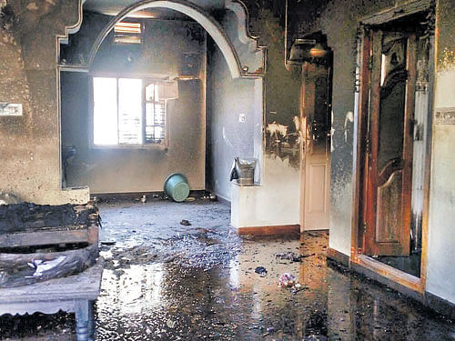 Barbaric Act: The house of a farmer in Manchanabele, Ramanagar district, which was locked from the outside and burnt down early on Sunday, killing two people. DH&#8200;PHOTO