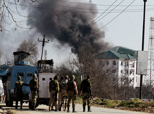 Smoke billowing out of the JKEDI building where militants have reportedly taken refuge after launching an attack on a CRPF convoy at Sampora Pampore, near Srinagar, on Sunday. PTI Photo