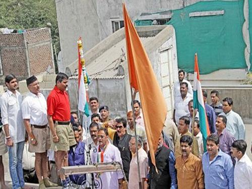 Cong's State President Arun Yadav hoising flag at RSS office Terrace. Courtesy:twitter