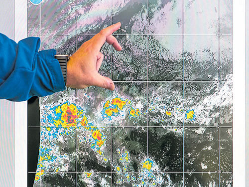 analysis A researcher refers to a weather radar satellite image during a briefing for an El Nino rapid response mission. photo by Kent Nishimura/nyt