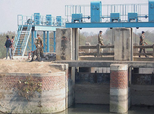 Army persons secure the Munak canal, near the village of Bindroli, in Haryana on Monday. The water crisis in Delhi eased on Monday with security forces securing the canal by evicting Jat agitators in Haryana state. PTI Photo