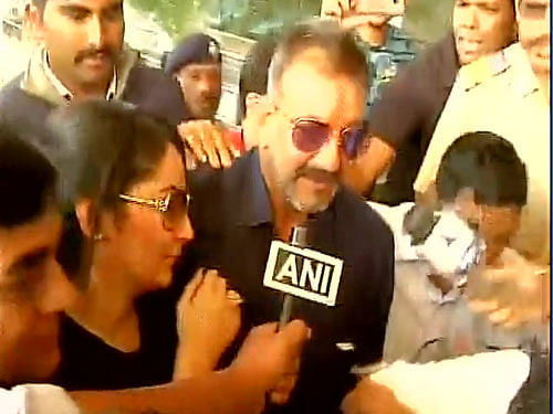 Clad in blue shirt and jeans, a smiling Dutt was escorted out of the imposing jail gates this morning after completing formalities and got into a car that drove him straight to Lohegaon Airport here to take a chartered flight to Mumbai. Image courtesy: ANI Twitter