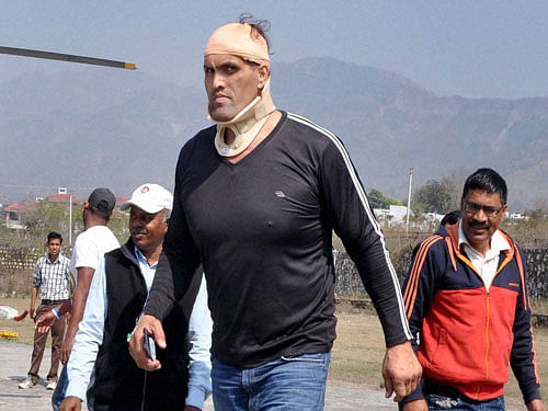 Former world heavy weight wrestling champion Dalip Singh Rana alias Khali going to the hospital in Dehradun after getting injured in a fight at Haldwani on Thursday. PTI Photo.