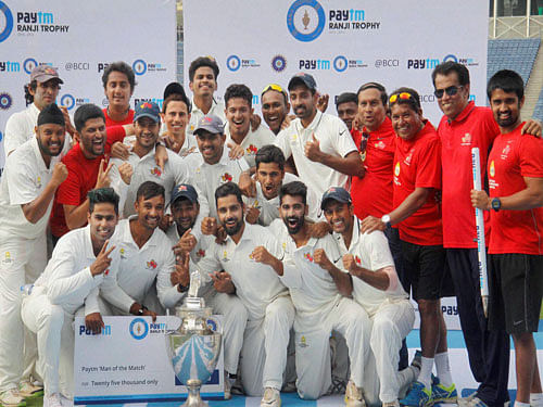 Mumbai team posing with the trophy after winning Ranji Trophy Final match against Saurashtra in Pune on Friday. PTI Photo.