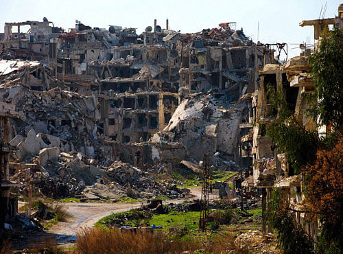 A Syrian man walks through a devastated part of the old city of Homs, Syria. PTI photo