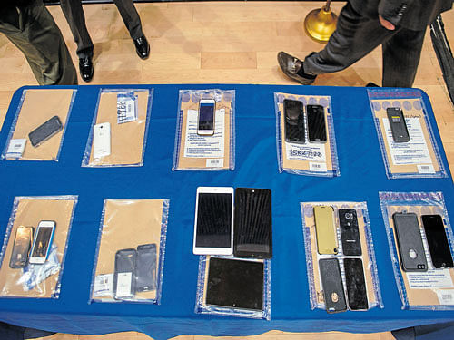 Encrypted smartphones held in police evidence on display in New York. INYT
