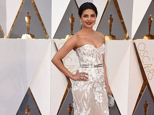Priyanka Chopra's debut Oscar outing in a white elegant strapless gown has impressed Indian fashion designers and colleagues from the film industry. PTI Photo