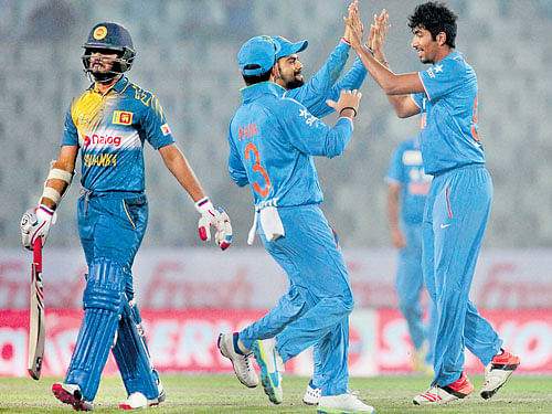 in fine rhythm: India's Jasprit Bumrah (right) celebrates with team-mates after dismissing Sri Lankan batsman Shehan Jayasuriya during their Asia Cup match in Dhaka on Tuesday. AFP