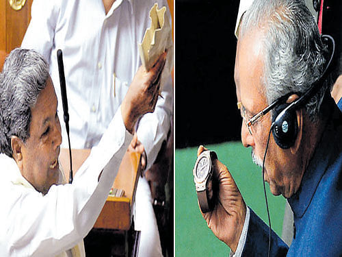 Chief Minister Siddaramaiah shows a packet containing his watch before it is handed over to Speaker Kagodu Thimmappa in the Assembly on Wednesday. The Speaker examines the controversial timepiece. DH photos