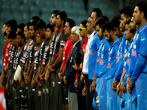 India, forground, and United Arab Emirates' cricketers stand in a moment of silence to pay tribute to former New Zealand captain Martin Crowe who has died, during the Asia Cup Twenty20 international cricket match in Dhaka, Bangladesh, Thursday, March 3, 2016. AP/PTI