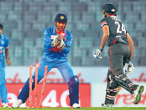 Indian skipperMSDhoni (left) executes a stumping to dismiss FarhanAhmed of theUAE during their Asia Cup T20 tie at the Sher-e-Bangla inDhaka on Thursday. AP/ PTI