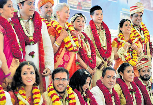 Couples from across the world took their wedding vows in Vedic style at the Art of Living International Ashram on Sunday. Picture by special arrangement