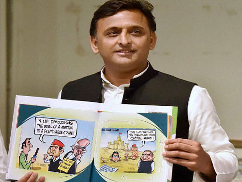 UP Chief Minister Akhilesh Yadav releases a book 'Tipu ka Afsana' based on cartoons on him in Lucknow on  Monday. PTI