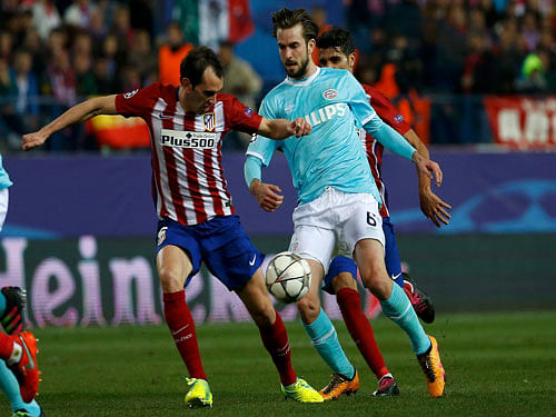 Atletico Madrid's Diego Godin in action against PSV Eindhoven's Davy Propper. Reuters