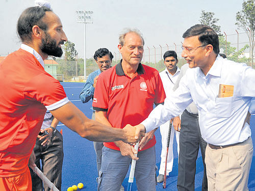 New beginning Indian captain Sardar Singh (left) greets Rajiv Yadav (right), Secretary Ministry of Youth Affairs and Sports, at the inauguration of the artificial hockey turf at SAI Centre (South). Coach of the National men's hockey side   Roelant Oltmans looks on. DH photo