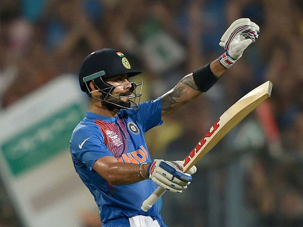 Indian batsman Virat Kohli celebrates after completing his half century against Pakistan during the ICC T20 World cup match at Eden Garden in Kolkata on Saturday. PTI Photo.