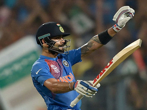 Indian batsman Virat Kohli celebrates after completing his half century against Pakistan during the ICC T20 World cup match at Eden Garden in Kolkata on Saturday. PTI Photo