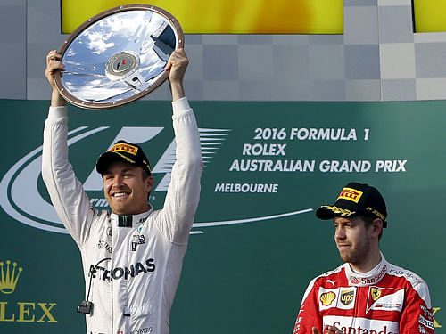 Mercedes F1 driver Nico Rosberg (L) celebrates after winning the Australian Formula One Grand Prix as third-place Ferrari F1 driver Sebastian Vettel looks on in Melbourne. Reuters Photo.