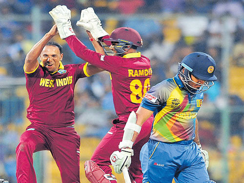 wrecker-in-chief: West Indies' Samuel Badree (left) celebrates with wicketkeeper Denesh Ramdin after dismissing Milinda Siriwardana of Sri Lanka. dh photo/ Srikanta Sharma R