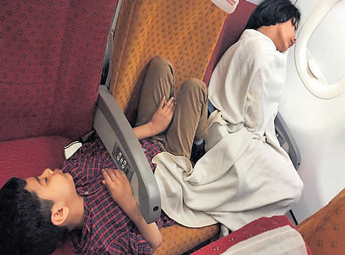 Children,women and elderly stayed overnight on board the Air India aircraft. PIC COURTSEY: IBNLIVE.COM