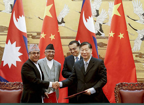 Chinese Premier Li Keqiang, rear right, with Nepal's Prime Minister Khadga Prasad Oli, rear left, attend a signing ceremony at the Great Hall of the People Monday, March 21, 2016 in Beijing, China. AP/PTI