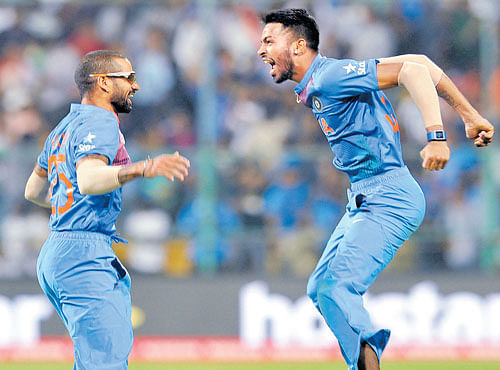India's ShikharDhawan (left) and Hardik Pandya celebrate after their nail-biting one-run victory over Bangladesh at the Chinnaswamy Stadium in Bengaluru on Wednesday. DH PHOTO