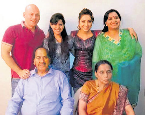 Close bond: (Standing from left) Dipak, Geeta, Asha and  Sumita. (Sitting) Father Laxman Singh Negi and mother Beena.