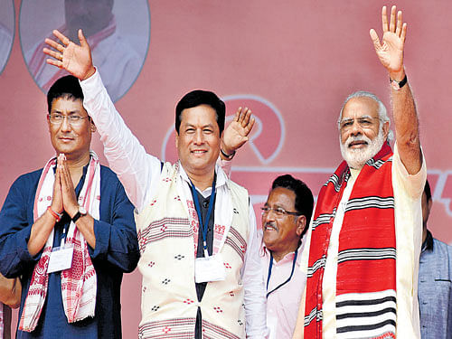 Finding his wave: Prime Minister Narendra Modi along with Union Minister and chief  ministerial candidate Sarbananda Sonowal at an election rally at Majuli Island in Assam on  Saturday. Ujjal Deb