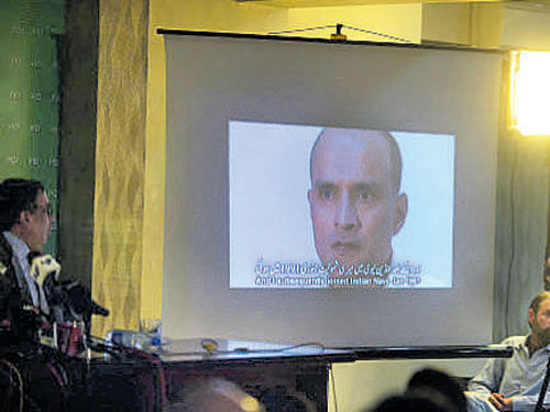 Members of the media watch a video showing Kul Bhushan Yadav, who was held on suspicion of being an Indian spy, during a press conference in Islamabad on Tuesday. AFP