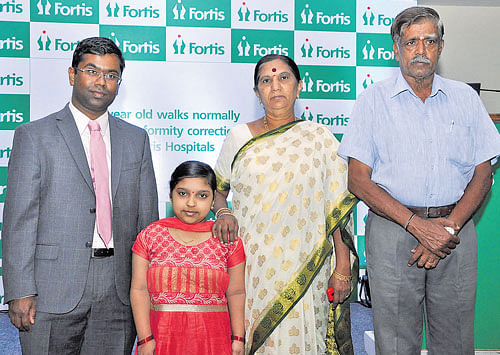 for a better tomorrow: Dr Mohan Puttaswamy (left), consultant reconstructive  orthopaedic surgeon at Fortis Hospitals, with Gaganashree and her grandparents. DH photo