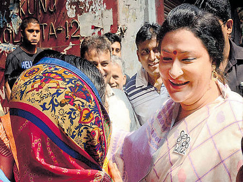 Actor and TMC candidate from Chowringhee Assembly  constituency Nayana Banerjee interacts with voters during  a campaign in Kolkata on Tuesday. PTI