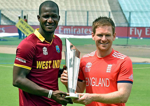 West Indies Captain Darren Sammy and England captain Eoin Morgan hold ICC T20 World Cup Trophy during a photo session at Eden Garden in Kolkata on Saturday prior to their final match. PTI Photo