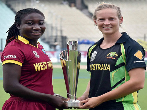 West Indies women's team captain Stafanie Taylor and Australia captain Meg Lanning hold ICC T20 World Cup Trophy for woman during a photo session at Eden Garden in Kolkata on Saturday prior to their final match. PTI Photo