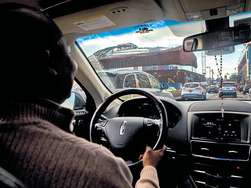 A file photo of an Uber  driver in New York. The ride-share company says UberPool now accounts for more than half of trips taken by its customers.  INYT