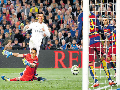 STEPPING UP: Real Madrid's Cristiano Ronaldo scores his team's second goal against Barcelona on Saturday. REUTERS