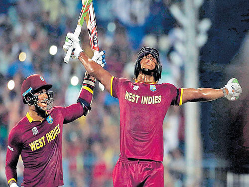 men of the match: Carlos Brathwaite (right) celebrates with Marlon Samuels after smashing his fourth six and taking the West Indies to victory in the World T20 final in Kolkata on Sunday. PTI