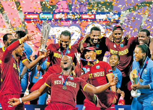 West Indies men and women players celebrate with their World T20 trophies at the Eden  Gardens in Kolkata on Sunday. PTI