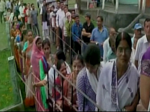 Voting for the first phase of Assam polls underway, people queue up to cast their vote. Courtesy: ANI