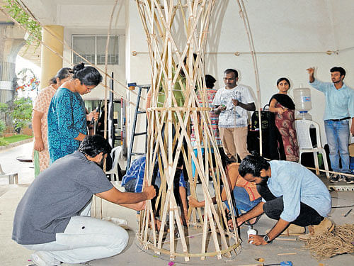 Members of the Center for Green Building Materials and Technology construct a bamboo structure at the Designguru festival in the city on Monday. DH&#8200;PHOTO