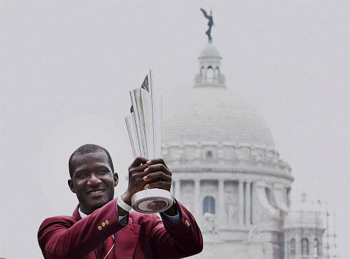 West Indies Captain Darren Sammy poses with ICC T20 World cup trophy in front of Victoria Memorial in Kolkata on Monday. PTI Photo