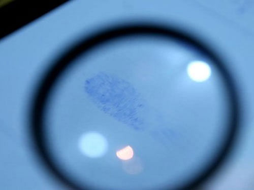 Another shot is of a magnifying glass highlighting a dusted fingerprint at a burgled pharmacy and a technician comparing collected prints to a suspect's, the Washington Times reported. Image courtesy Twitter.