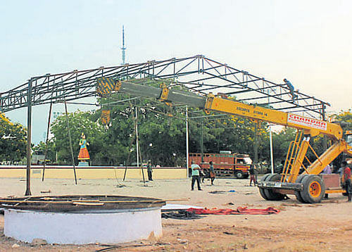 Workers prepare a giant stage at Island Ground in Chennai where Jayalalithaa will kick-start her poll campaign. DH Photo