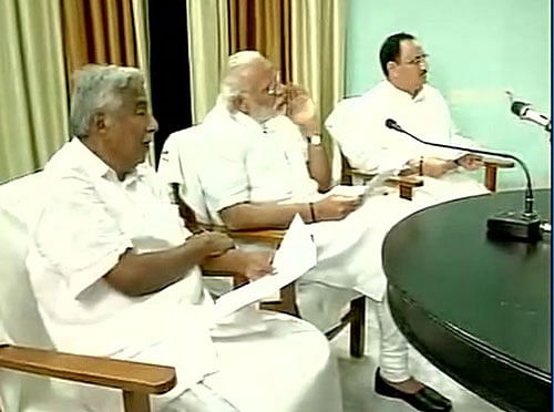 PM Modi, Kerala CM Oommen Chandy and Union Health Minister JP Nadda take stock of the situation in Kollam. Photo courtesy: ANI Twitter