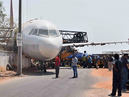 Crane carrying an Air India aircraft lost its balance and crashed near Begumpet airport in Telangana on Sunday. The flight was empty and was being brought to the airport for training purposes. PTI Photo